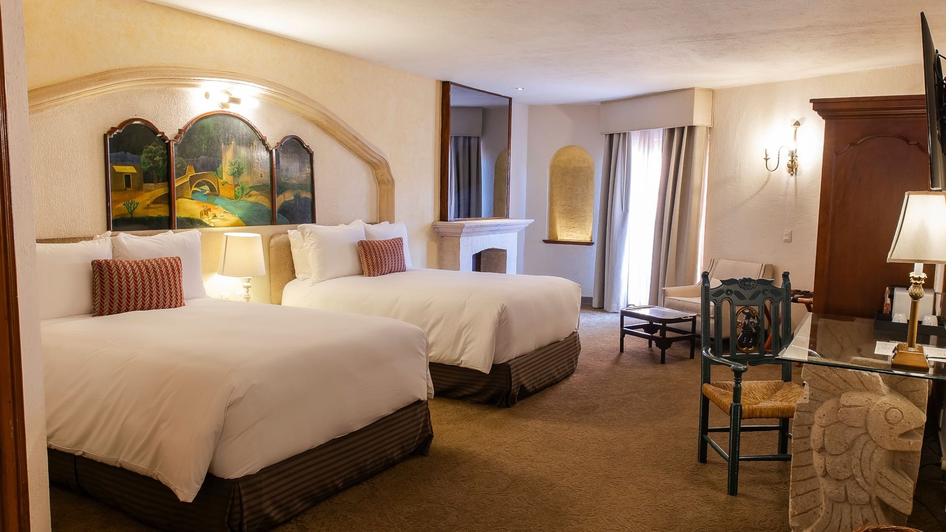 King Presidential Suite with two beds, arched artwork, fireplace, and seating area at Quinta Real Zacatecas