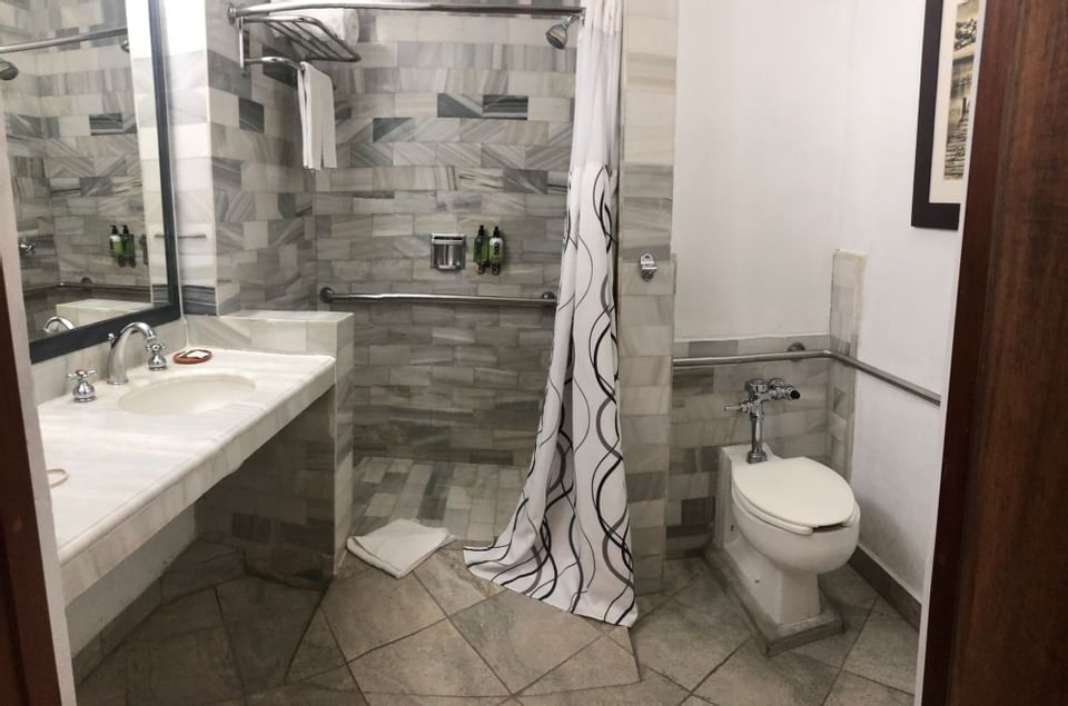 Bathroom interior featuring the ADA in a Hotel room at Porta Hotel del Lago