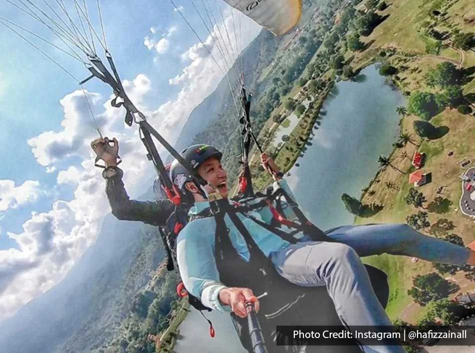 A man was taking a selfie while tandem paragliding in KKB Paragliding Park - Lexis Suites Penang