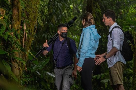 A couple on a guided tour in the forests near Rio Celeste