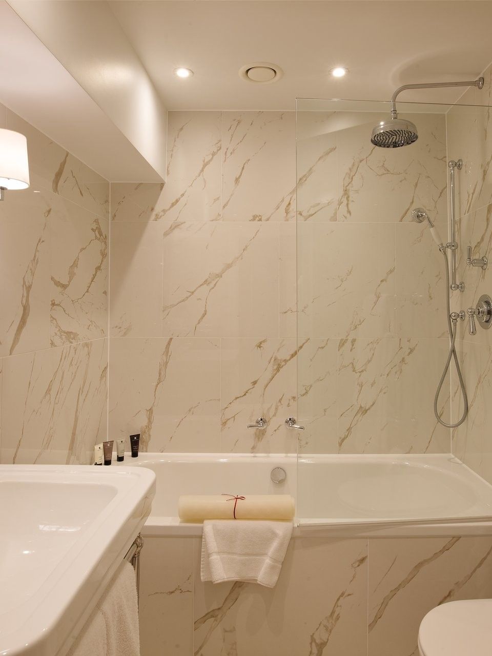 Hyde Park Suite bathroom featuring a marble vanity with bathtub at The Capital Hotel, Apartments and Townhouse