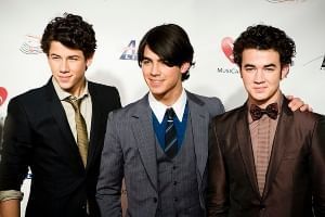 The Jonas Brothers on a red carpet. You can see them perform at The Amway Center in Orlando, Florida on October 13 and 16.