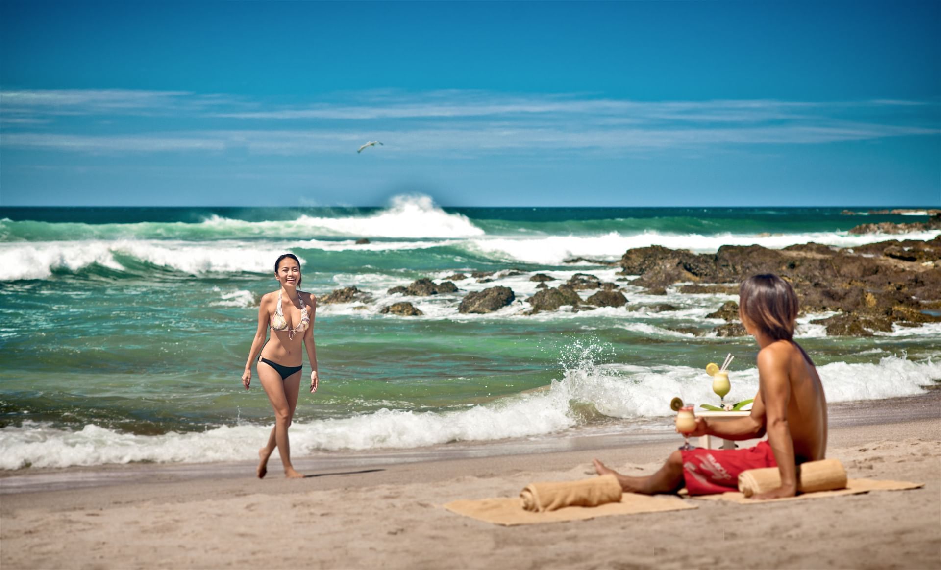 A couple having fun at the beach near Cala Luna Boutique Hotel