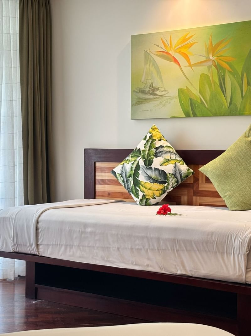 Garden View Room with a tropical-themed bed and artwork at Warwick Fiji Resort and Spa, Korolevu.