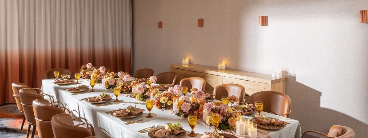 Elegant private dining room at Novotel Sydney Darling Harbour decorated for special celebration with seating for guests