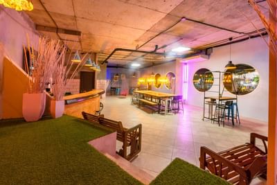 Lounge area with eclectic furniture, lighting, and round wall mirrors at Panama Hotel