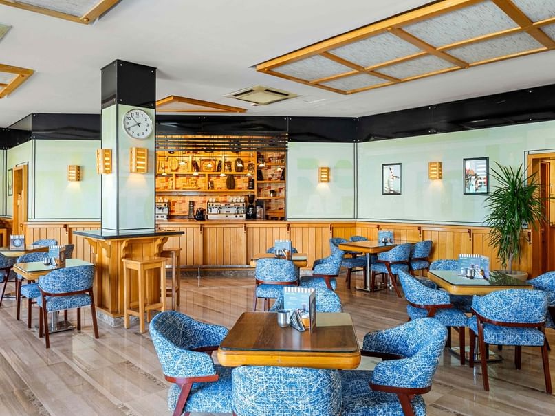 Columbus Bar interior with tables, chairs, and a bar counter at Pickalbatros Dana Beach Resort in Hurghada.