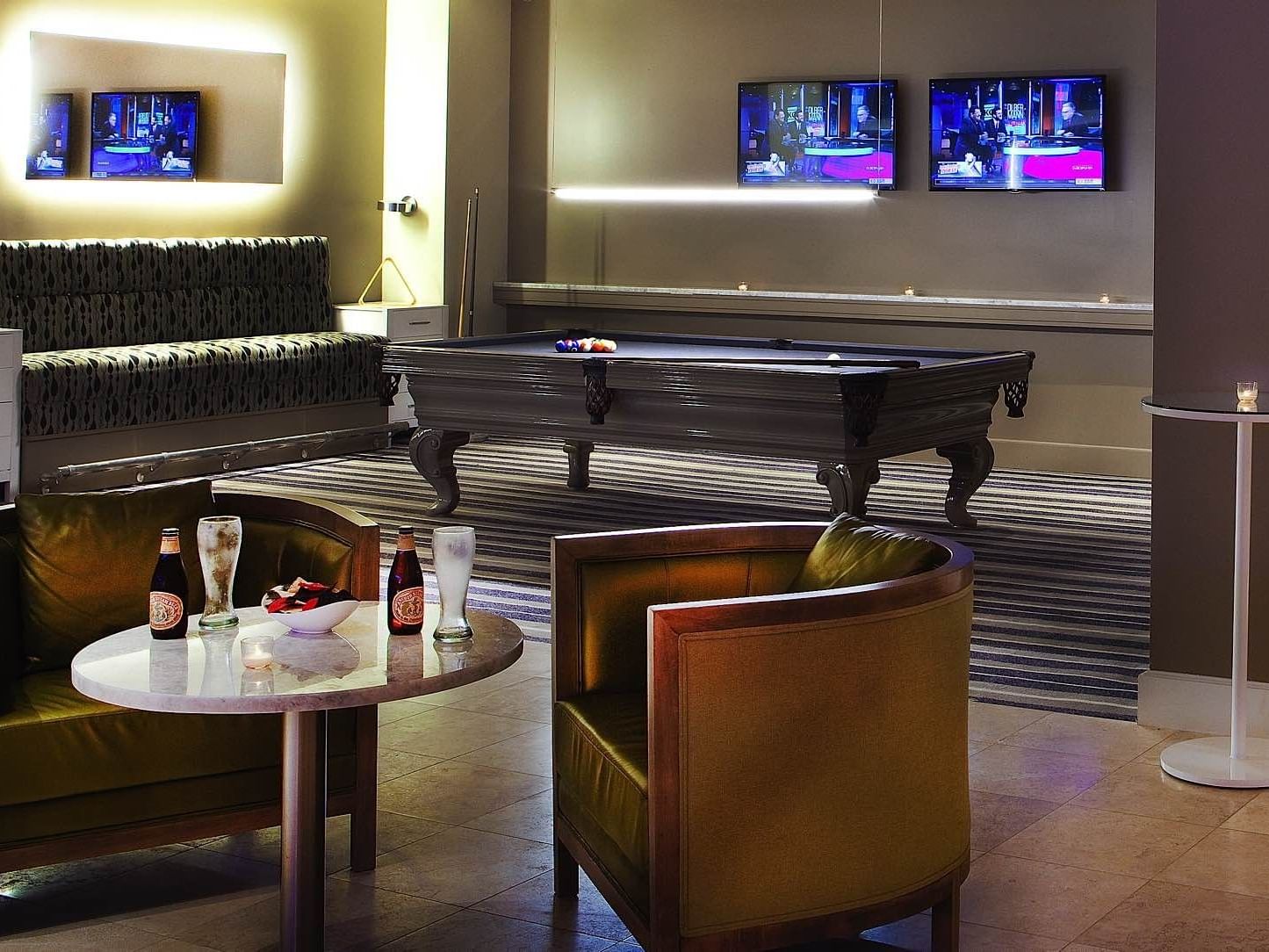 Lounge & billiards table area in a game room at Ocean Place