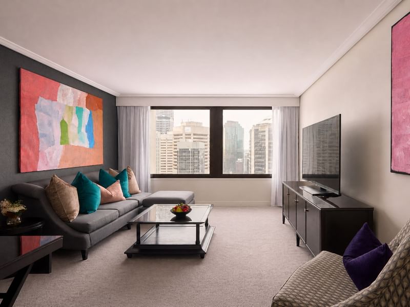 Elegant living area with modern art and cityscape view at Sofitel Brisbane Central in Brisbane City.