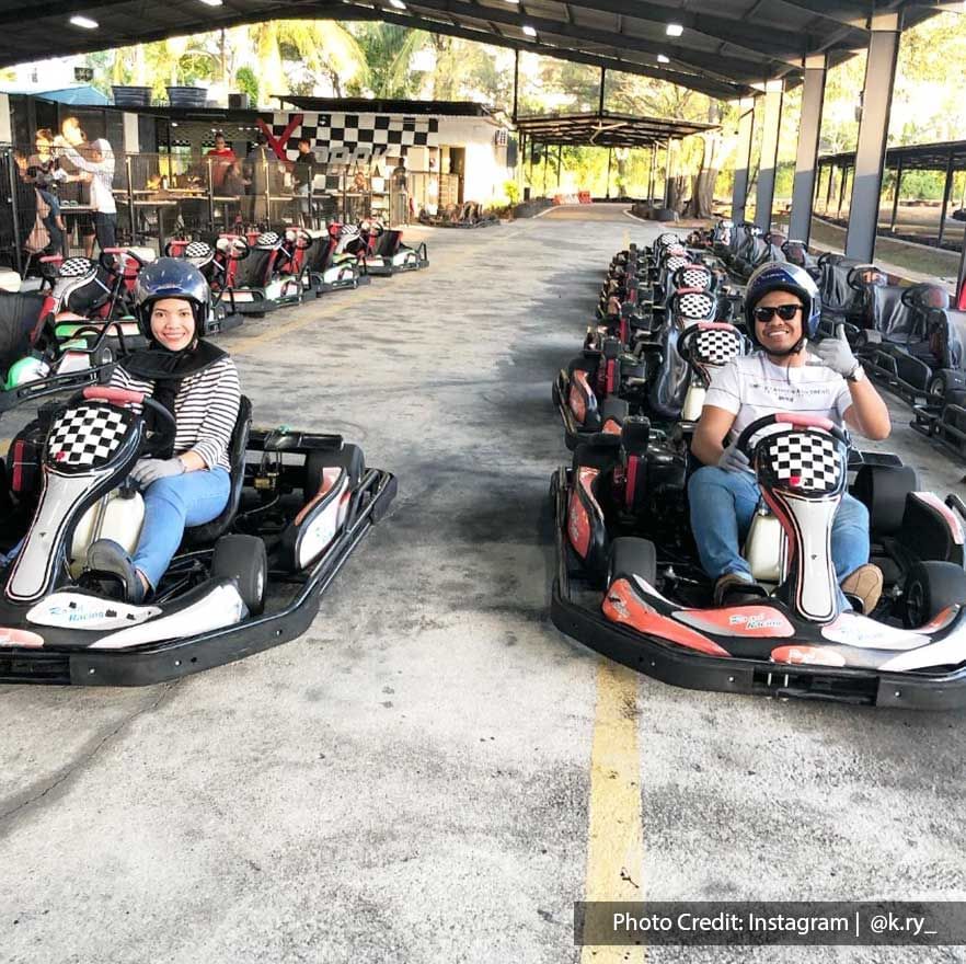 a guy and a girl sitting inside a go kart