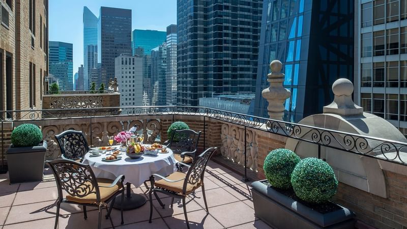 Outdoor balcony with city skyline view and dining setup at Warwick New York.