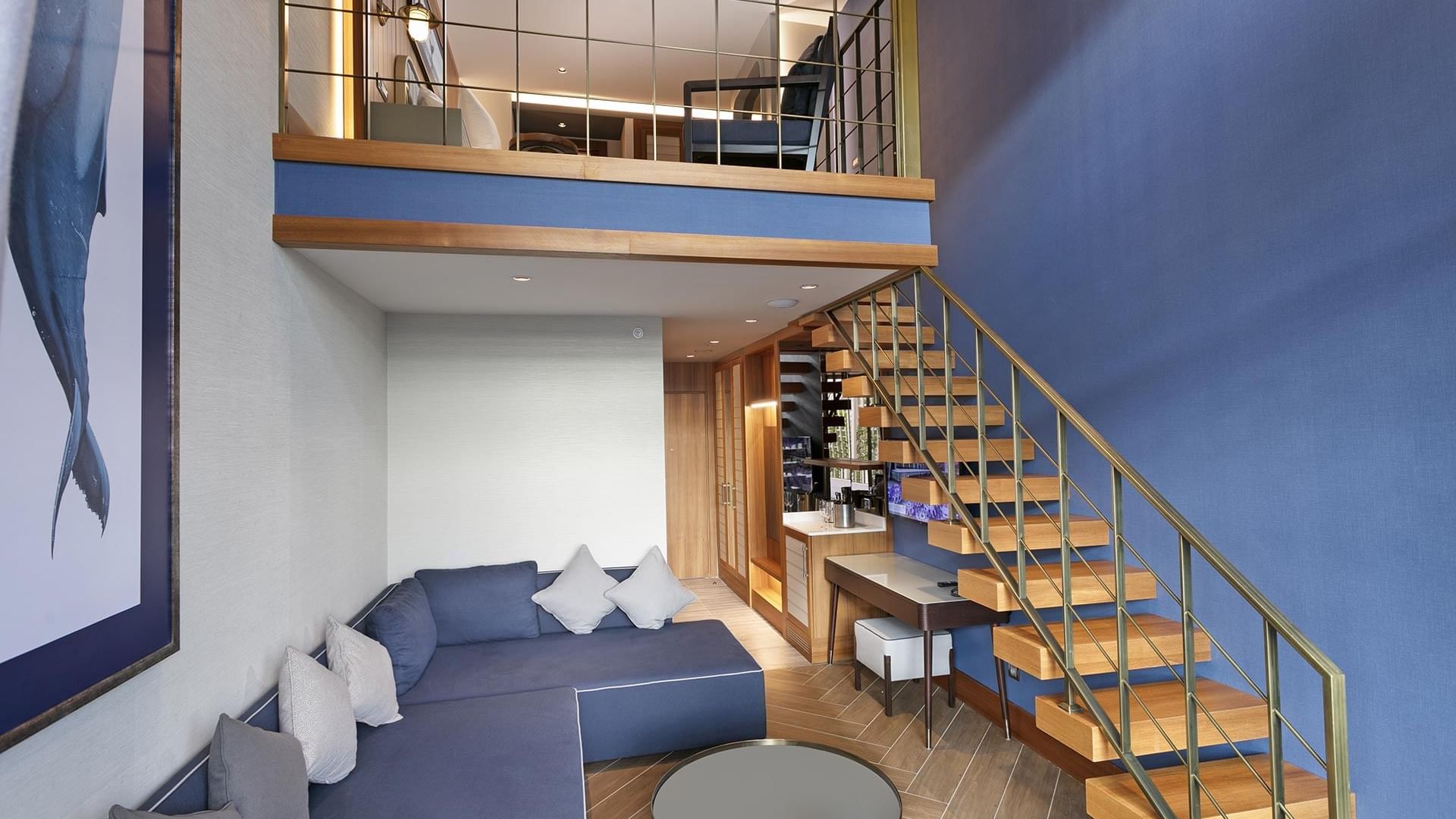 Элегантный номер в Titanic Deluxe Lara – Annex Duplex Suite с голубыми стенами, деревянной лестницей и балконом.