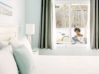 a person reading a book outside a hotel room