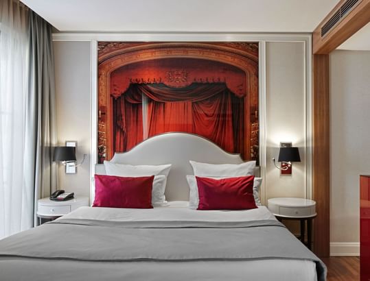 Nightstands by the cozy bed in Superior Room with wooden floors at Titanic Gendarmenmarkt Berlin