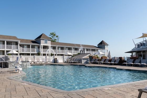 Outdoor swimming pool surrounded by lounge chairs at Anchorage By The Sea