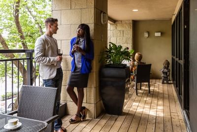 View of a Man & Woman talking at Metterra Hotel on Whyte
