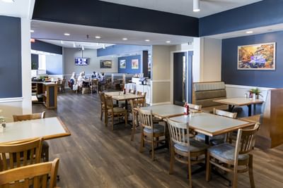 Spacious and welcoming dining area with wooden flooring in Gales Restaurant in Yarmouth at Rodd Grand Yarmouth