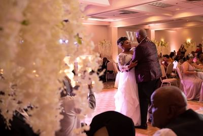 Newlywed couple enjoying their first dance surrounded by guests during a wedding reception at Lake Natoma Inn