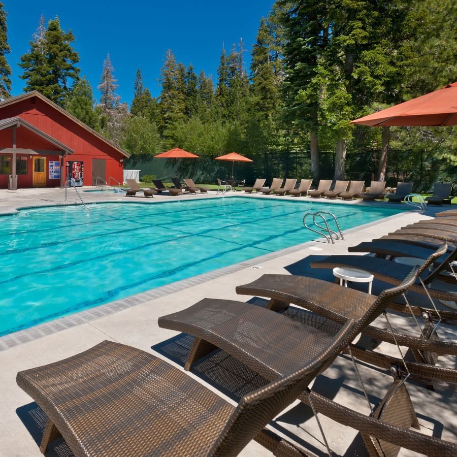 Granlibakken's outdoor lap pool with lounge chairs on a clear summer afternoon