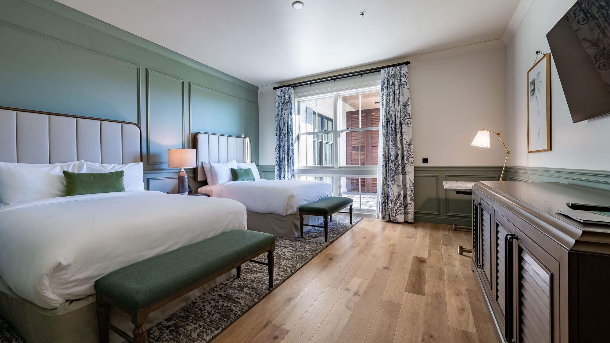 Twin beds & wooden floors in Golf View Queen Room at Camp Creek Inn