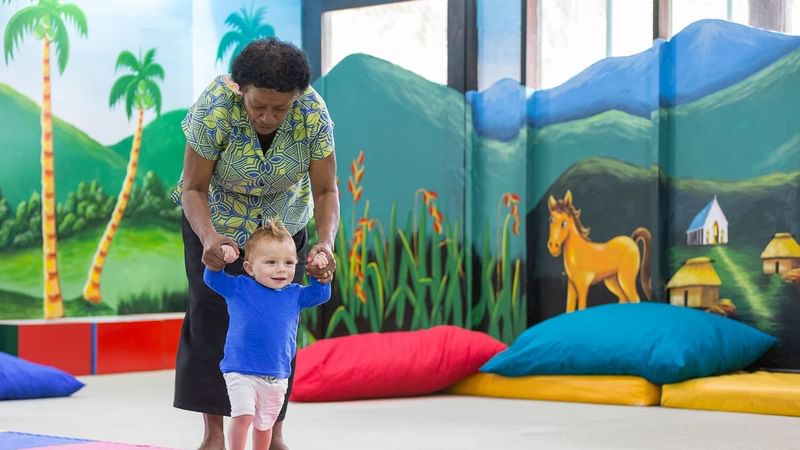 A worker & baby in the Warwick Fiji Daycare at Warwick Fiji