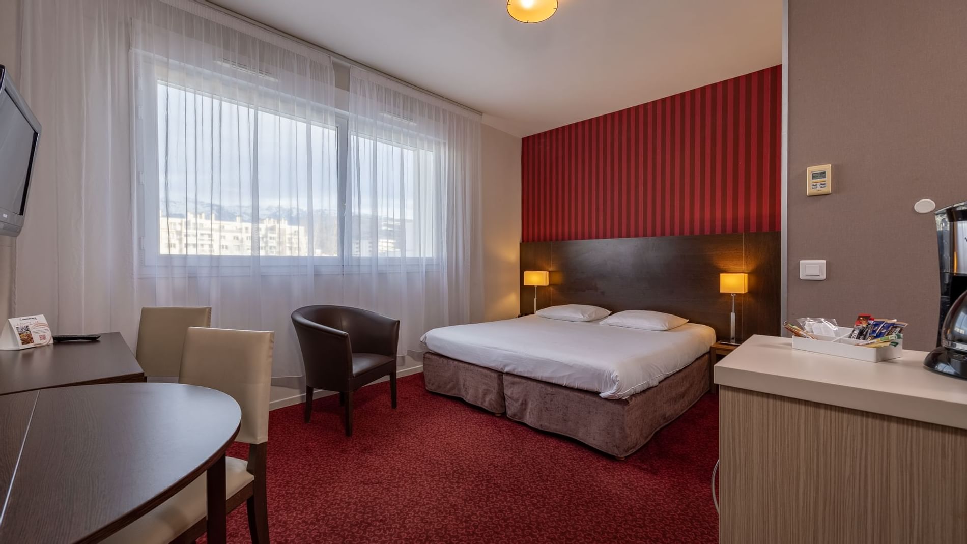 Dining table & bed in a Bedroom at The Originals Hotels