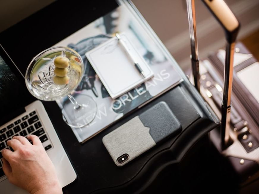 A Martini next to a laptop at The Royal Frenchmen Hotel