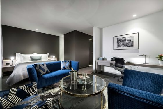 Comfy lounge area by the king bed in Premier Suite at Melbourne Hotel Perth