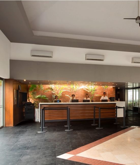 Staff in the front desk reception area at Plaza Pelicanos Club Beach Resort