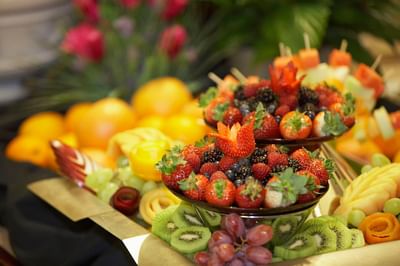 Glass bowls filled with fresh strawberries, blackberries, and kiwi fruit slices served at Spencer Hotel & Conference Centre