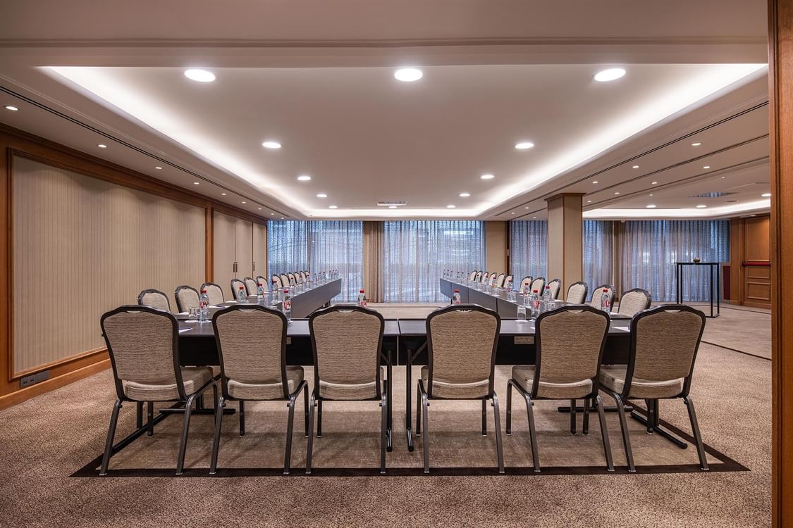 A large meeting room with chairs and a long table arranged in rows at Warwick Brussels Bruxelles