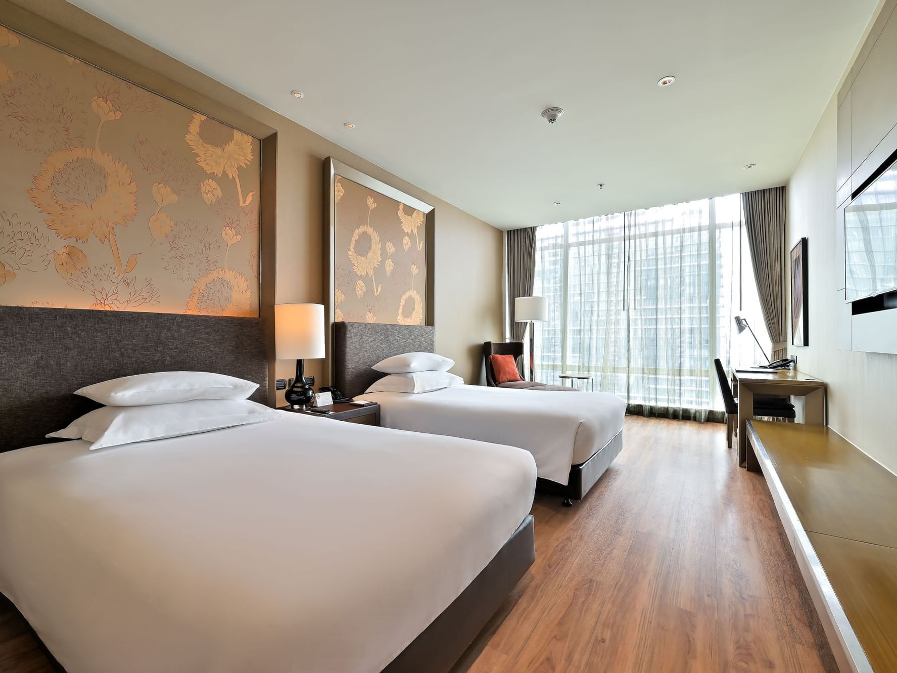 Two comfy beds and a TV in Superior Room at Eastin Grand Hotel Sathorn