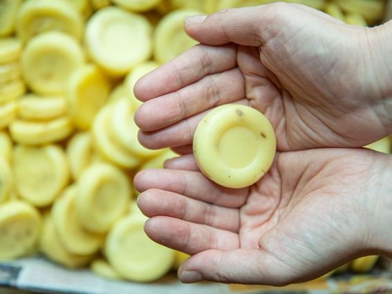 A person is holding a yellow soap in their hand at Park Hotel Group