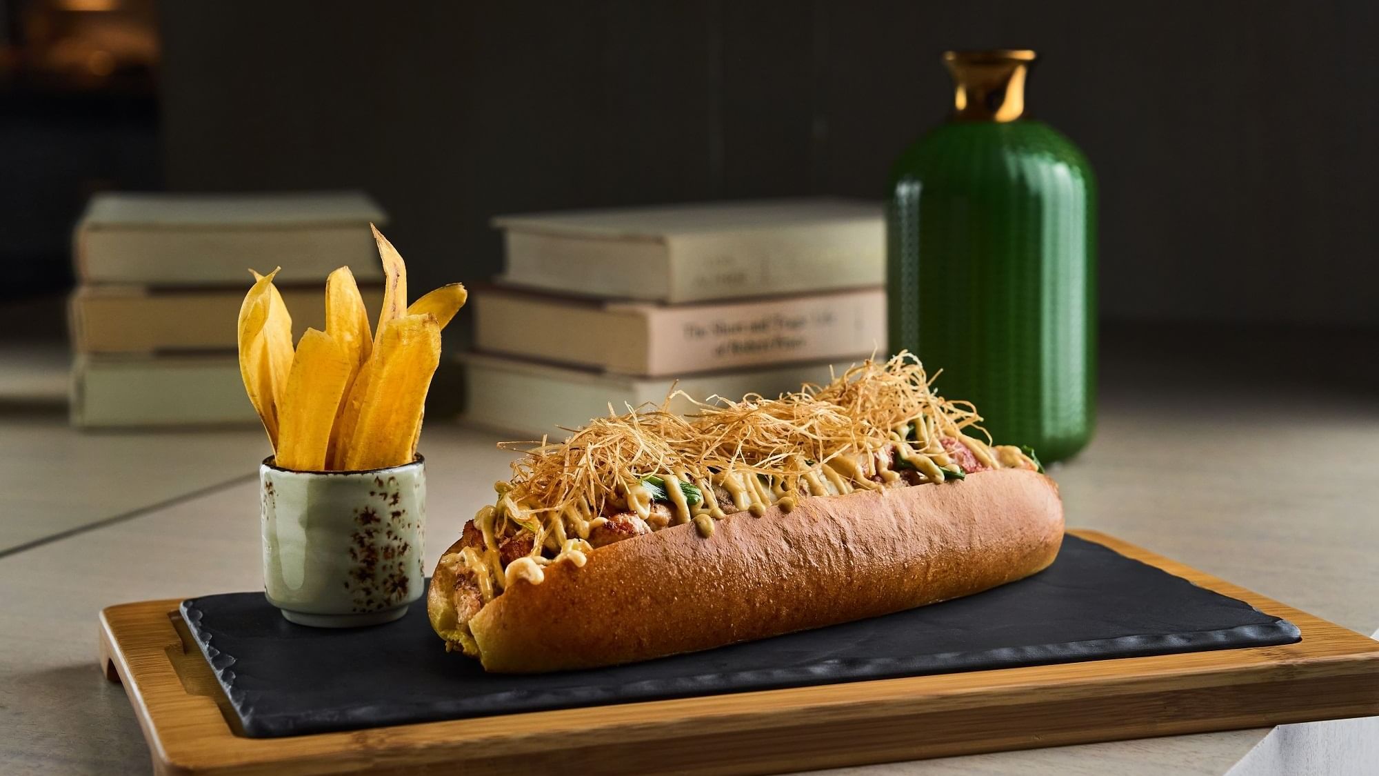 Hot dog served with chips in Pacific Groove Restaurant & Lounge at Paramount Hotel Dubai