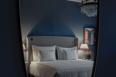 Deluxe Room's bed captured from the mirror at The Sparrow Hotel
