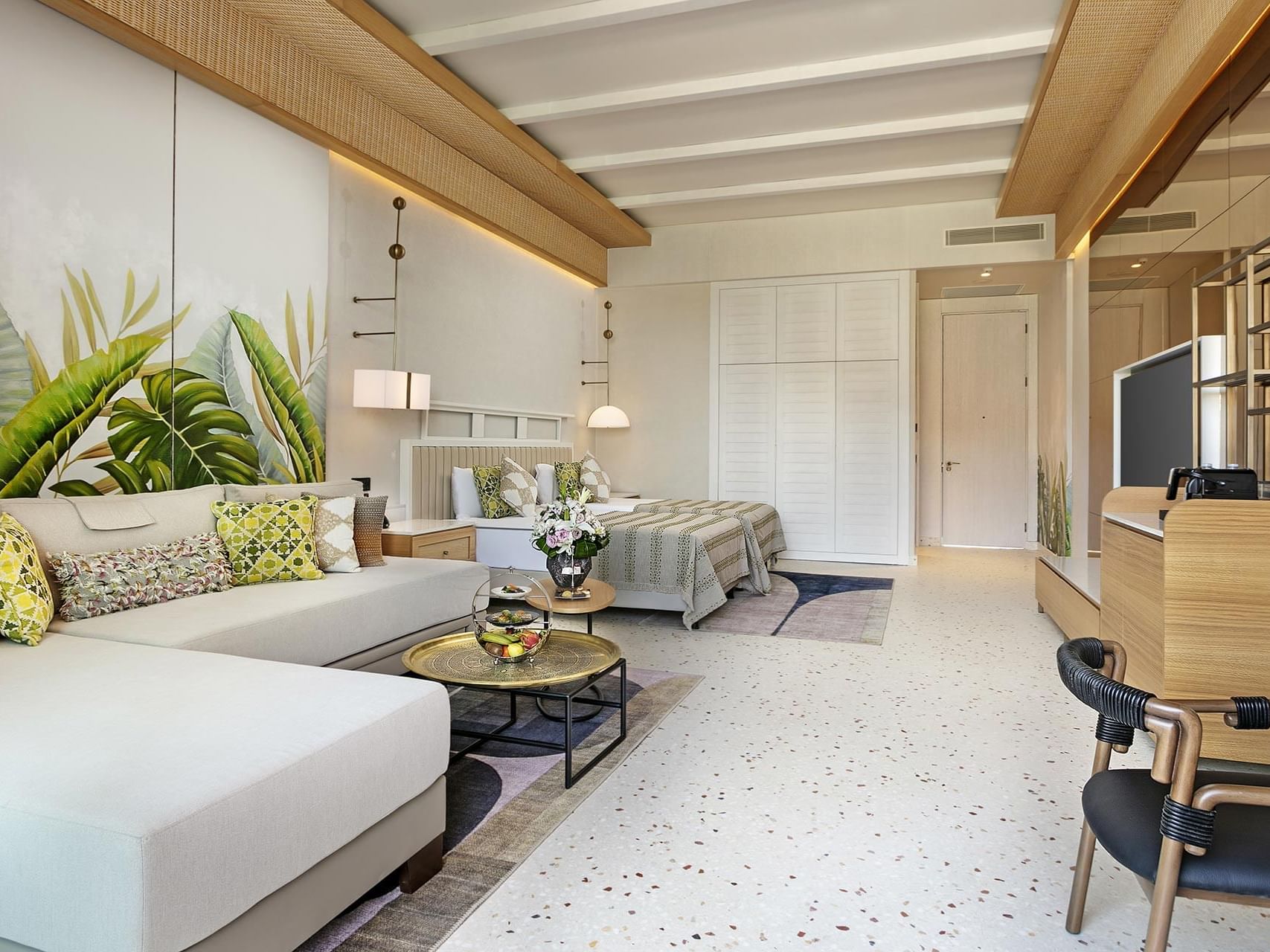 TV & seating area by the beds in Lagoon Swim-up Room at Cullinan Belek