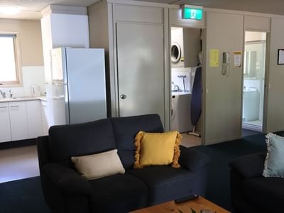 Living room with two couches and a kitchen area in La Trobe University - Villas.