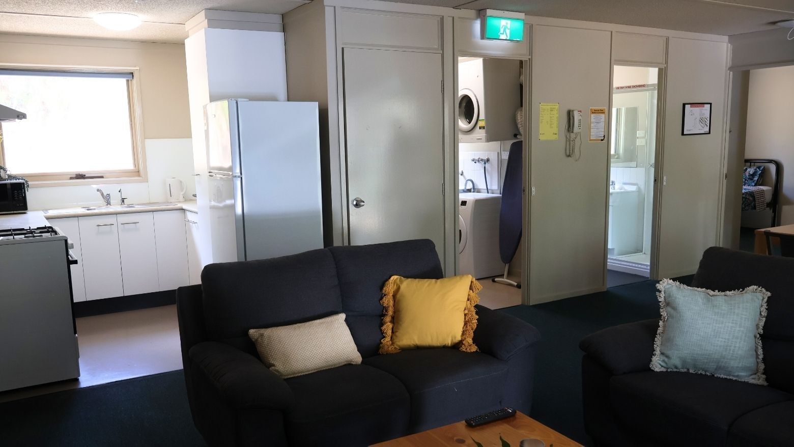 Living room with two couches and a kitchen area in La Trobe University - Villas.