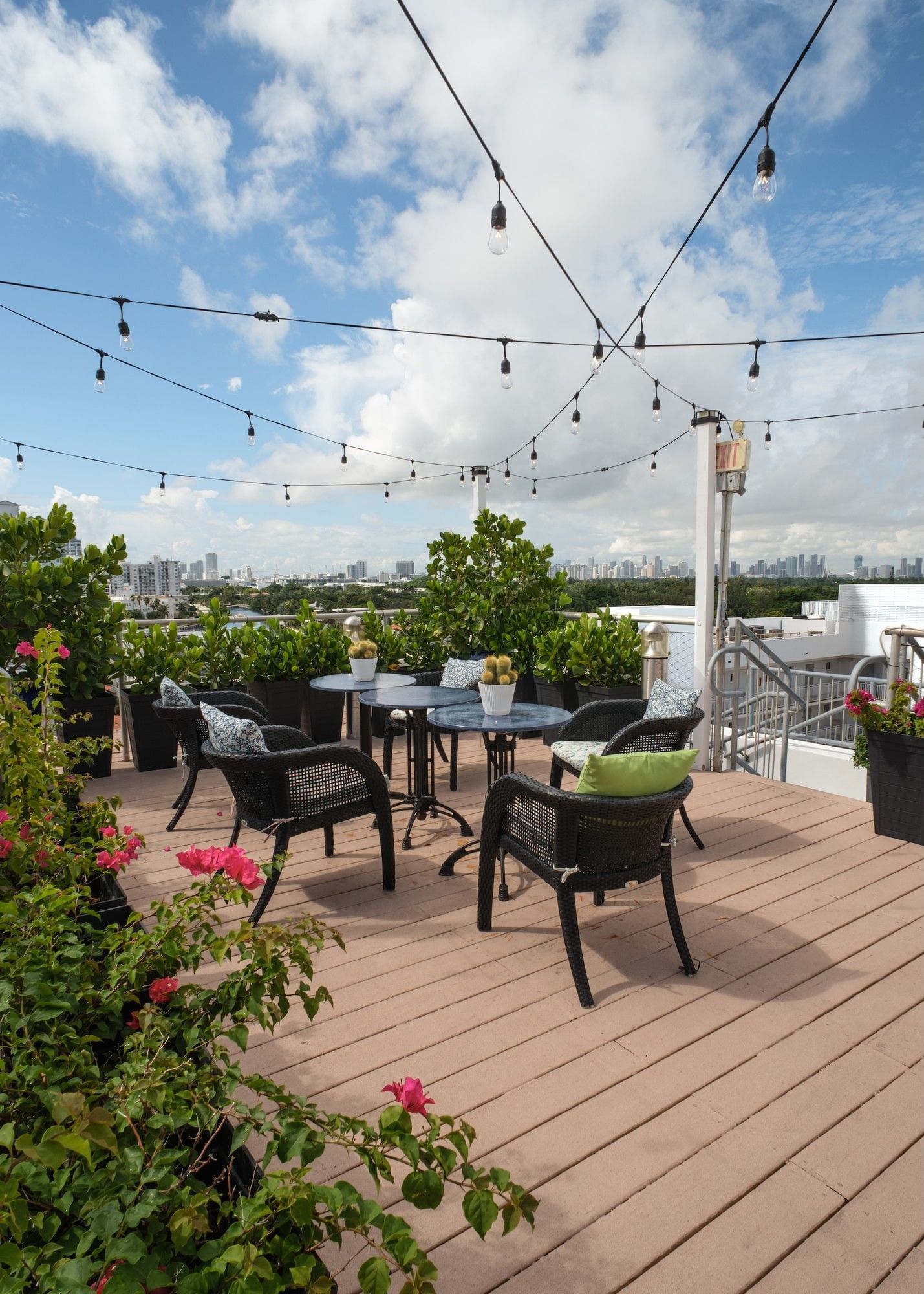 A rooftop patio with outdoor seating and string lights