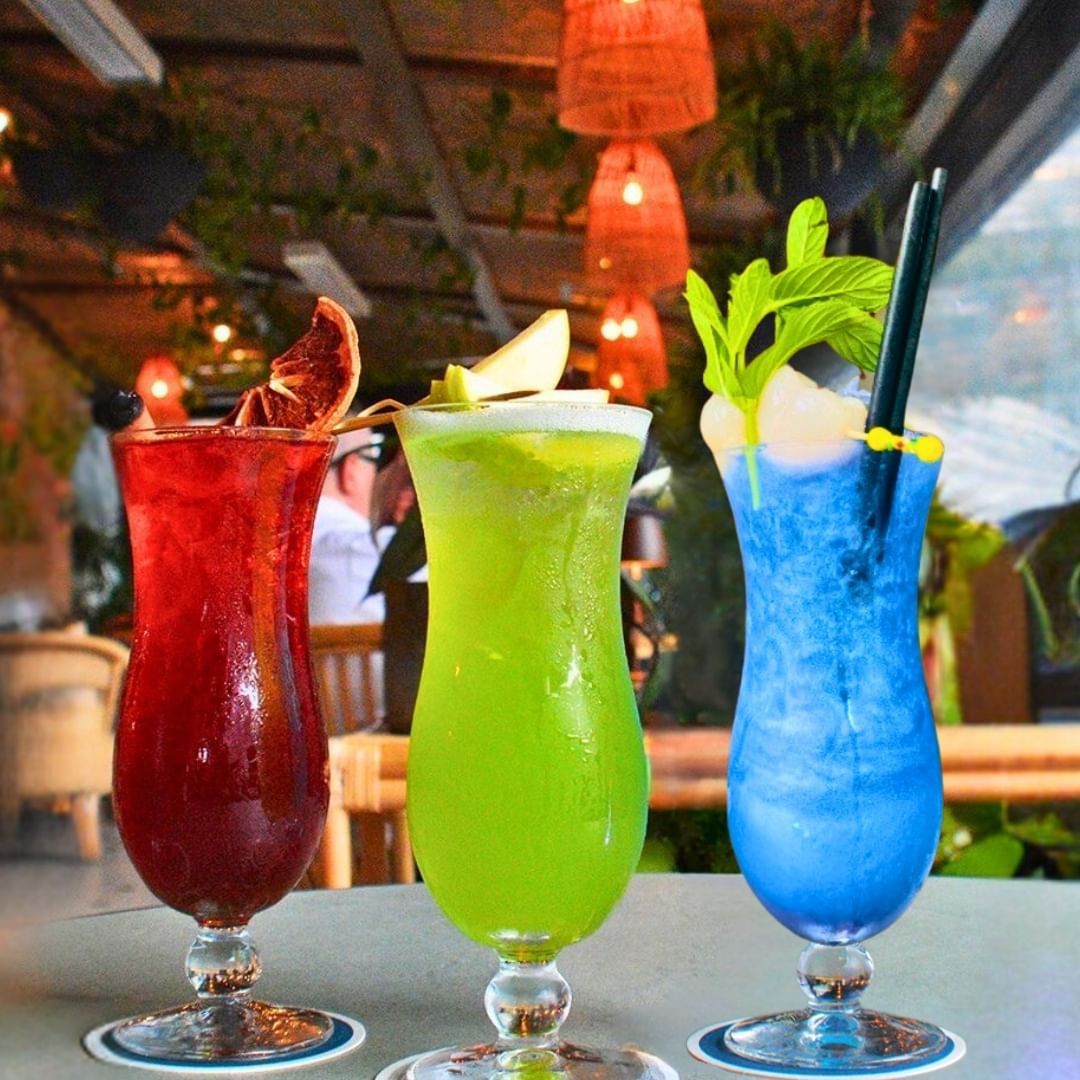 Three colorful cocktails. one blue, one green and one red