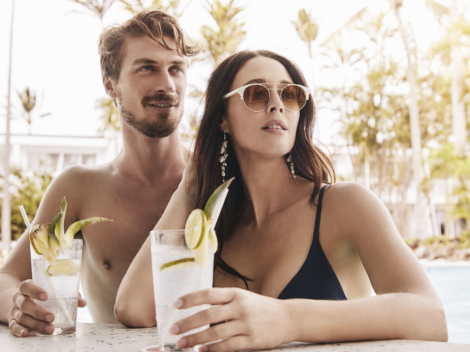 A couple enjoying cocktails in the pool bar at Daydream Island