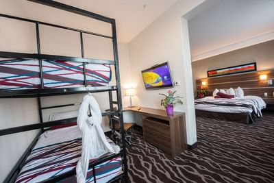 Cozy bunk beds and a working desk in the Family Bunk Suite at Encore Suites Grande Prairie