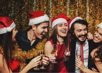 A group wearing Santa hats and Christmas outfits at Amora Hotel Jamison Sydney