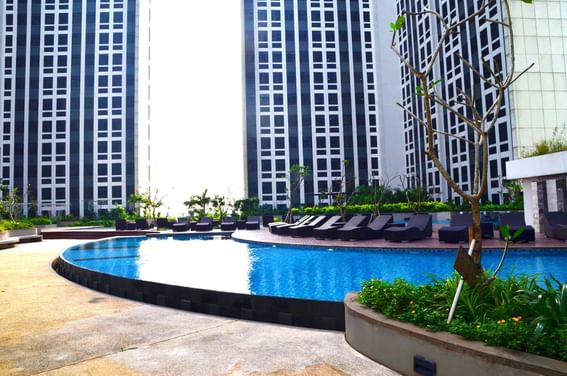 Outdoor swimming pool by the hotel buildings at LK Cikarang Hotel & Residences