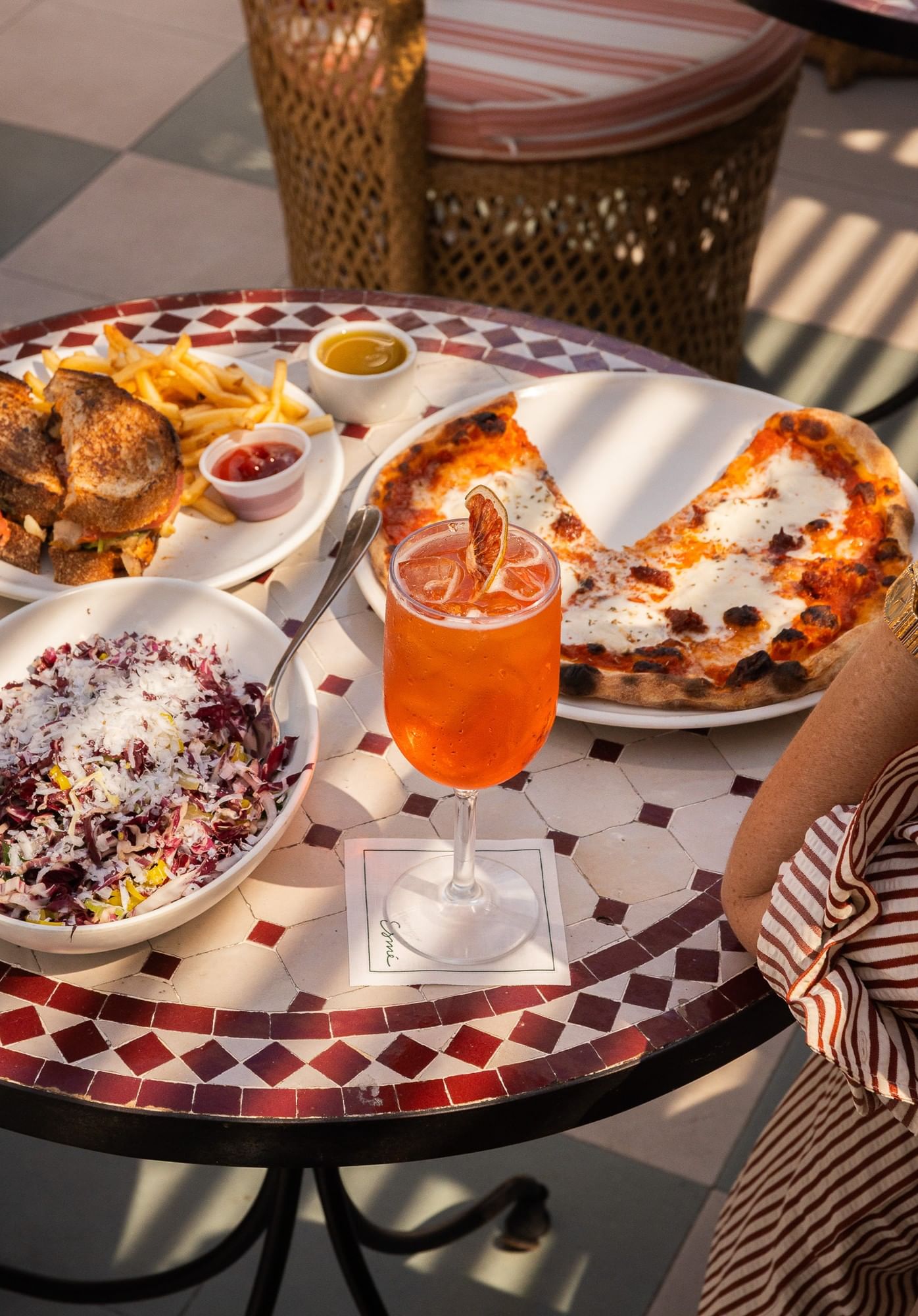 A table with a variety of food and a drink.