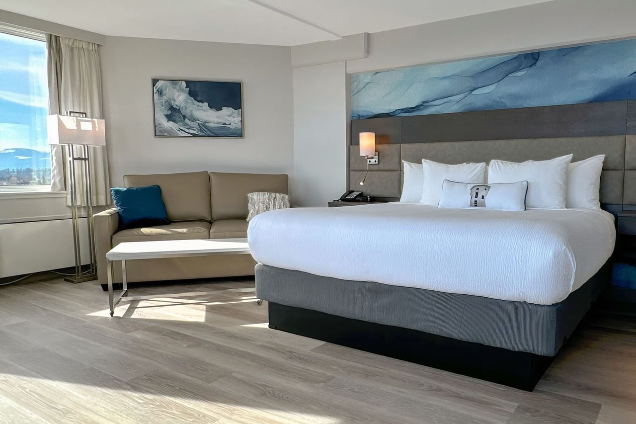 Hotel guestroom with King bed, a sofa and coffee table