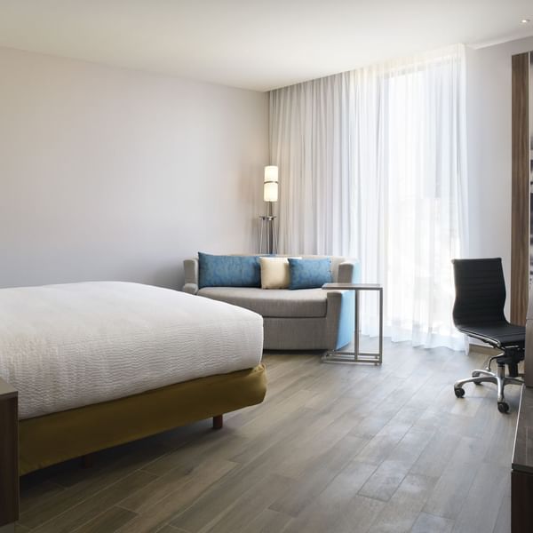 King bed with sofa in Superior Room at Fiesta Inn