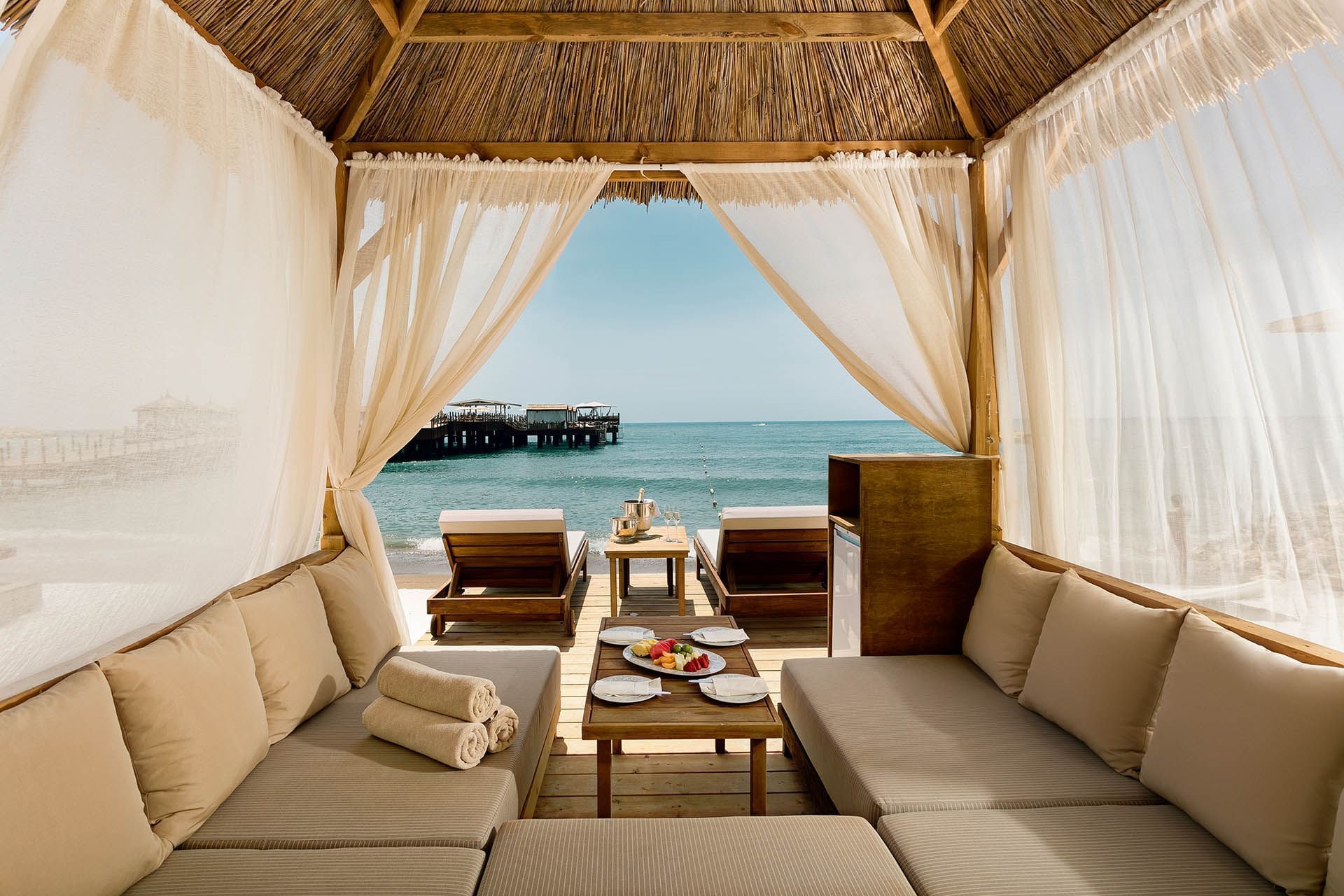 Luxurious beachfront cabana with seating area at Titanic Mardan Palace
