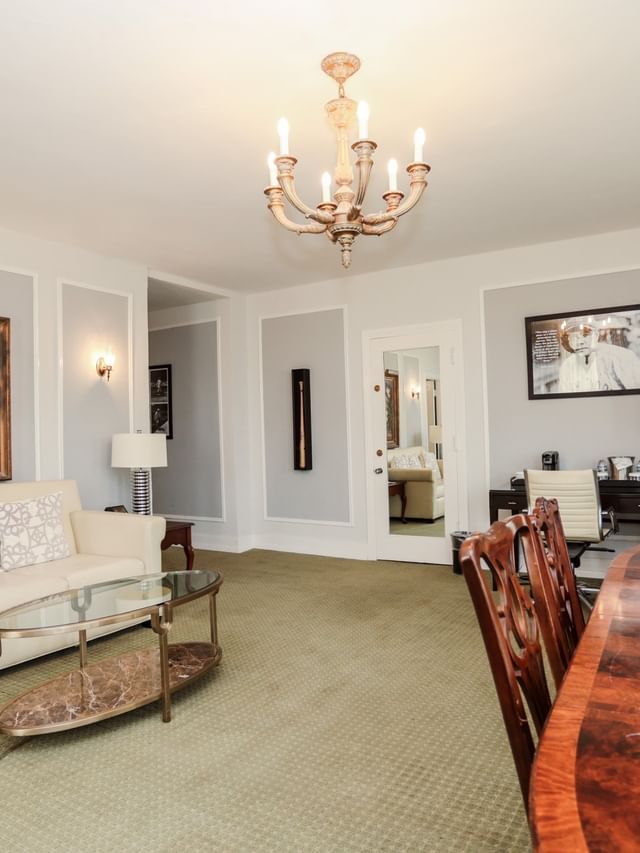 The Babe Ruth Bright living space with a wooden dining table and floral wall art at Arlington Resort Hotel & Spa
