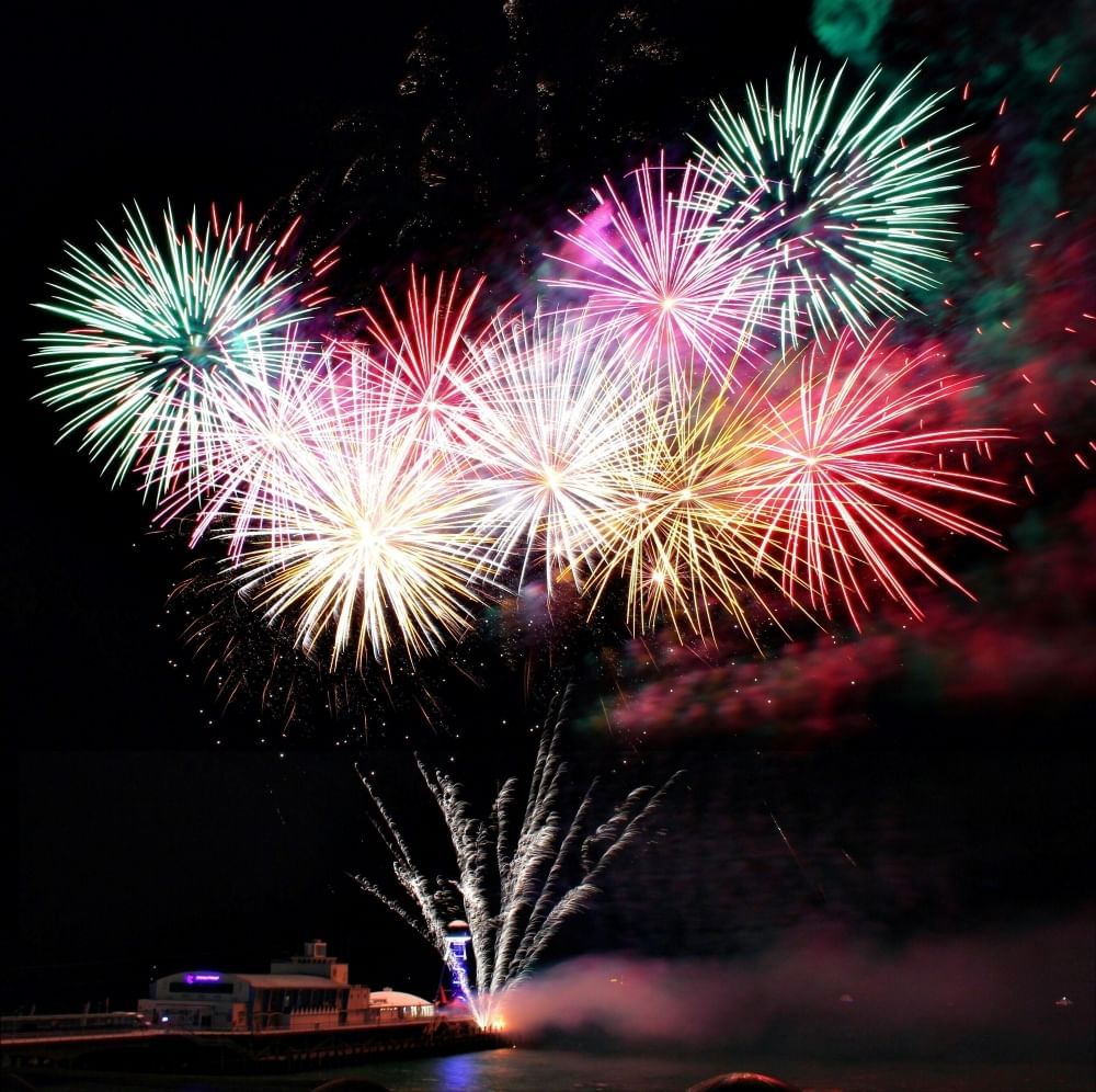 A series of colorful fireworks explode at night on July 4th.